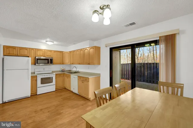 a large white kitchen with a large window