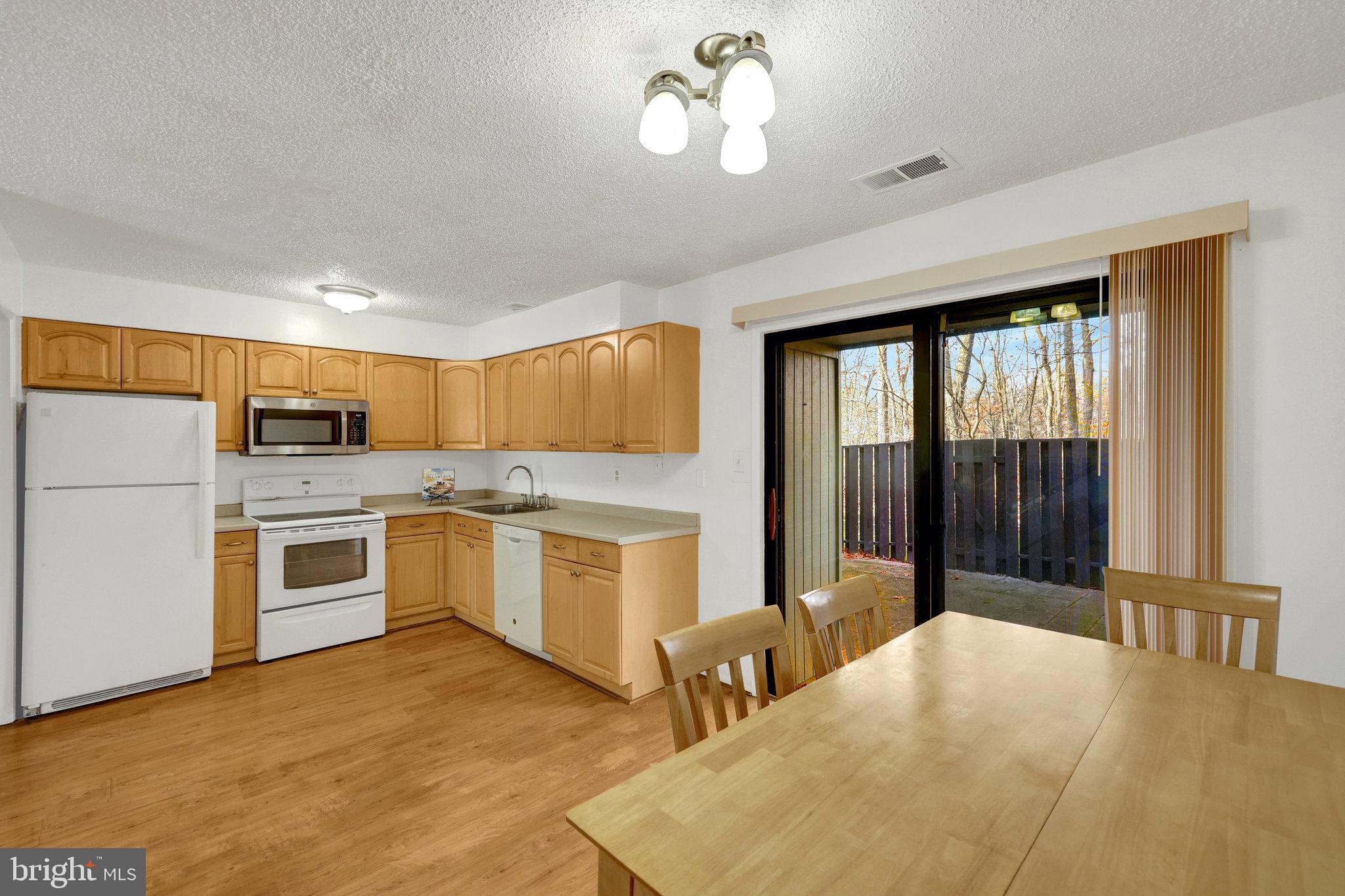 2142 Cartwright Place Reston, VA 20191 - Photo 10 of 46 a large white kitchen with a large window