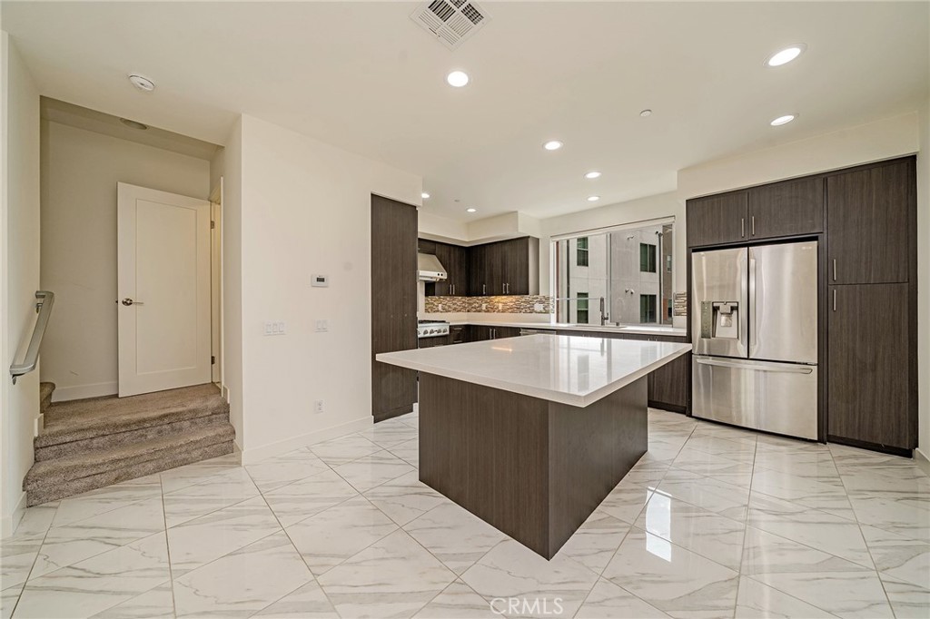 248 Rockefeller Irvine, CA 92612 - Photo 7 of 42 a kitchen with stainless steel appliances granite countertop a refrigerator and a sink