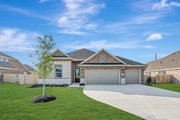 a front view of a house with a yard garage and outdoor seating