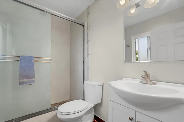 a bathroom with a sink toilet and shower