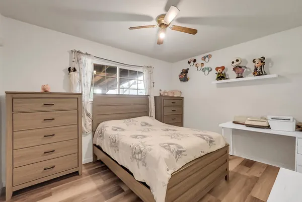 a bedroom with a bed and a dresser