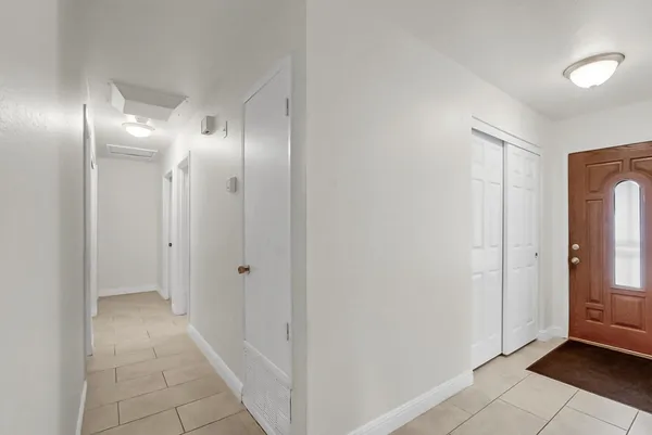 a view of a hallway with wooden floor