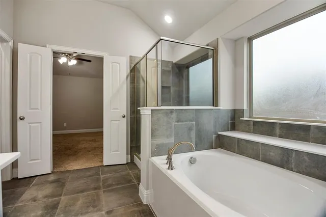 a bathroom with a bathtub and a shower