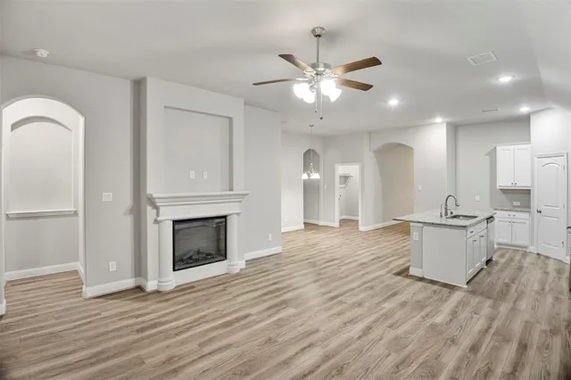 a view of a kitchen with a sink and a fireplace