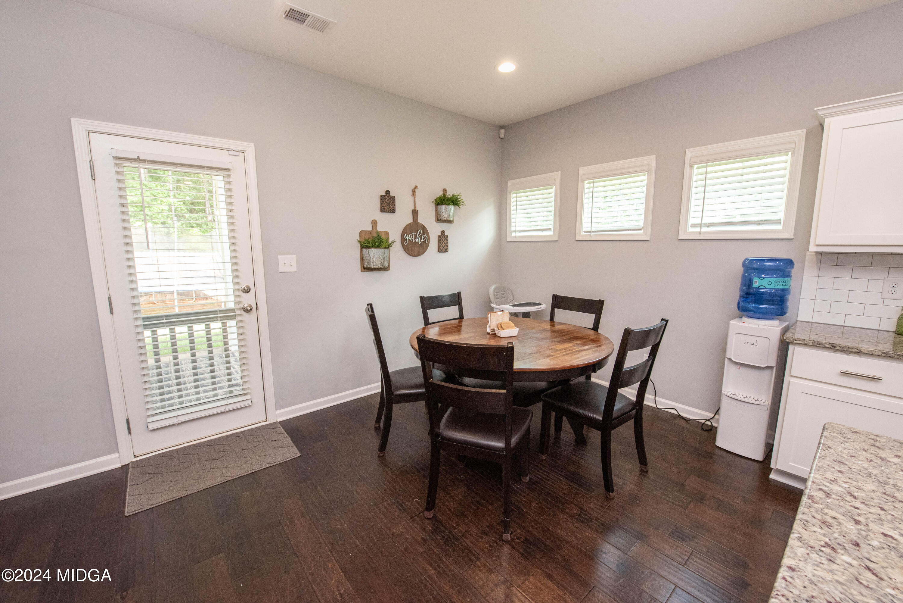 103 Wax Myrtle Way Perry, GA 31069 - Photo 15 of 62 a view of a dining room with furniture and wooden floor