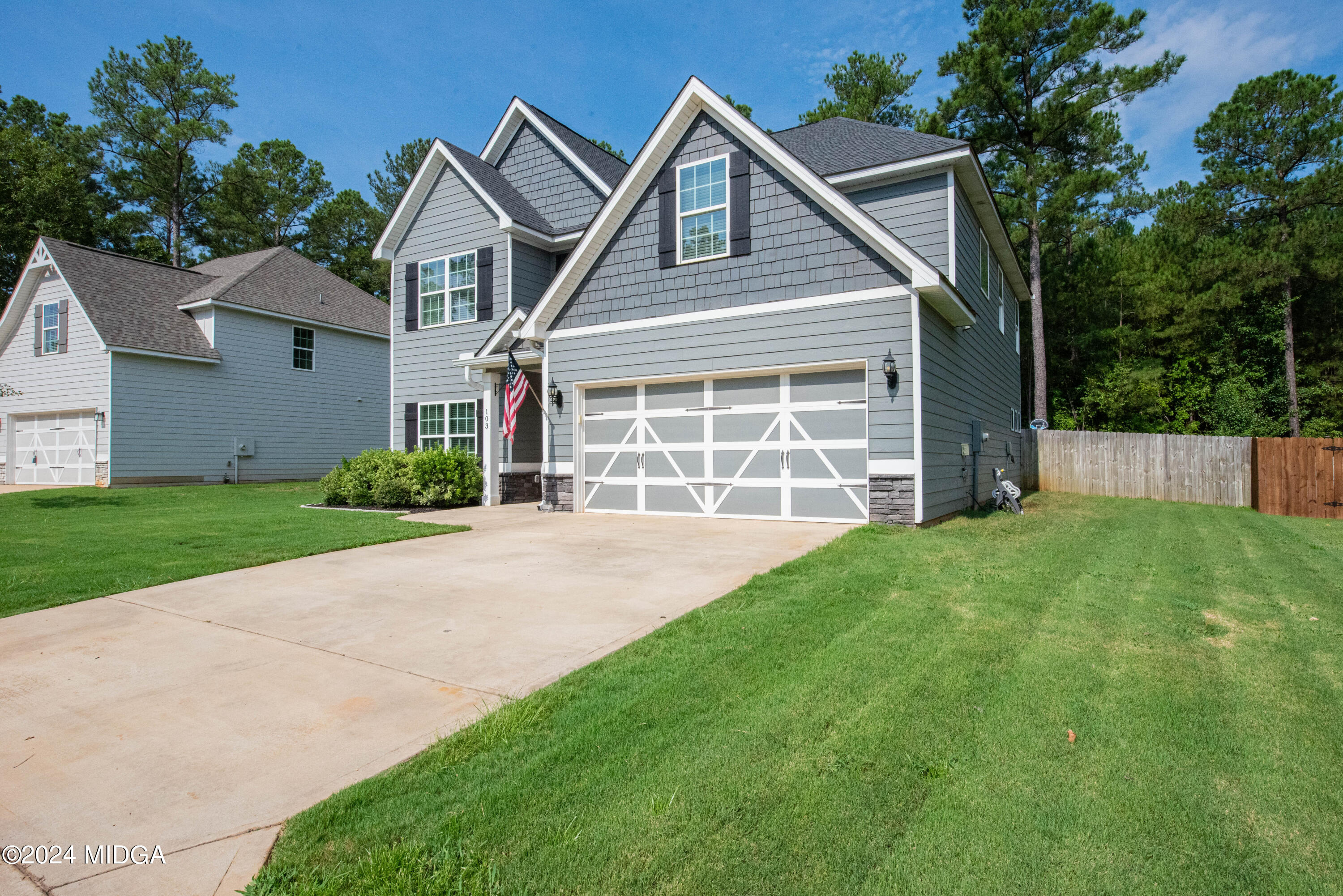 103 Wax Myrtle Way Perry, GA 31069 - Photo 3 of 62 a front view of a house with a yard and garage