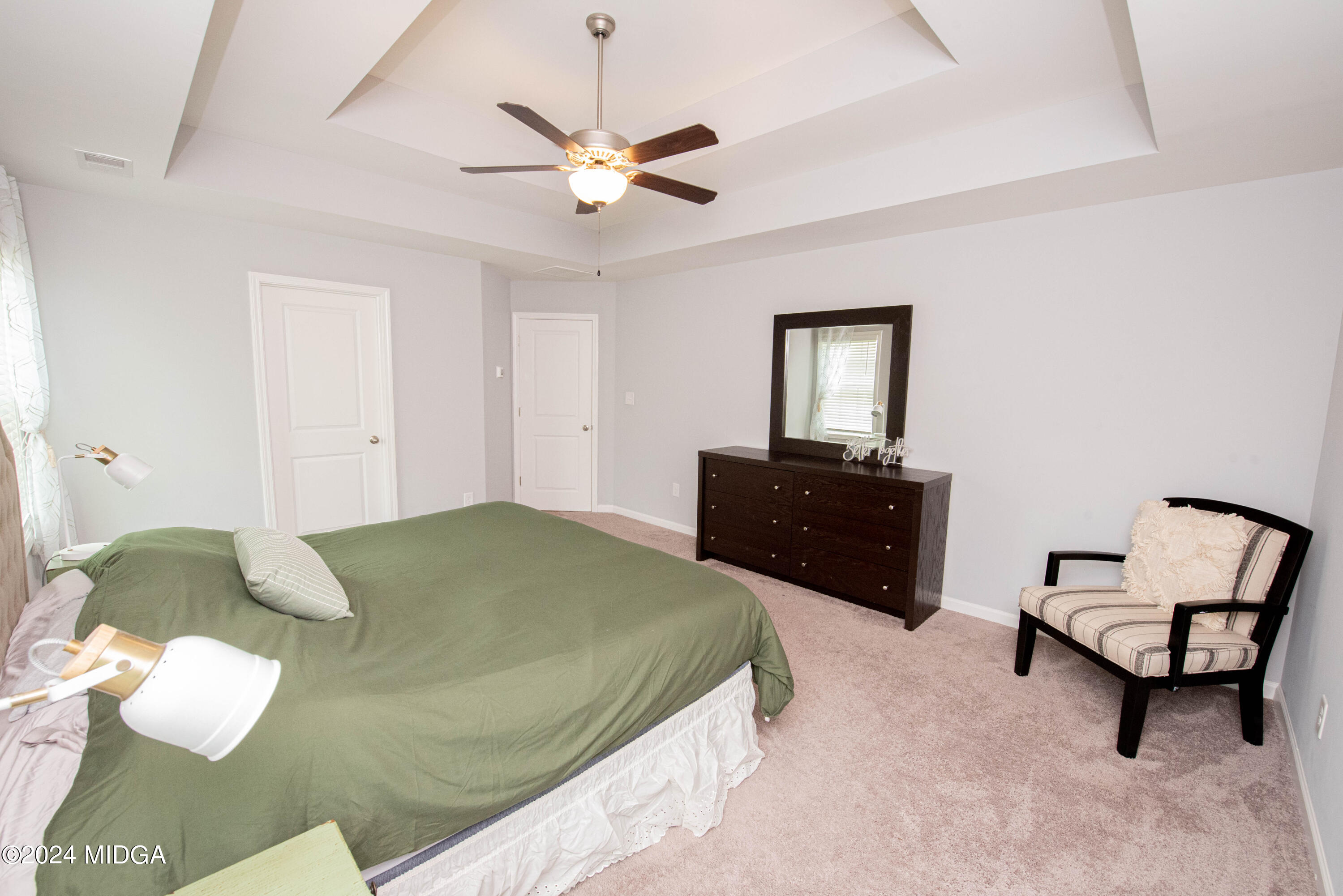 103 Wax Myrtle Way Perry, GA 31069 - Photo 36 of 62 a spacious bedroom with a bed and a chair