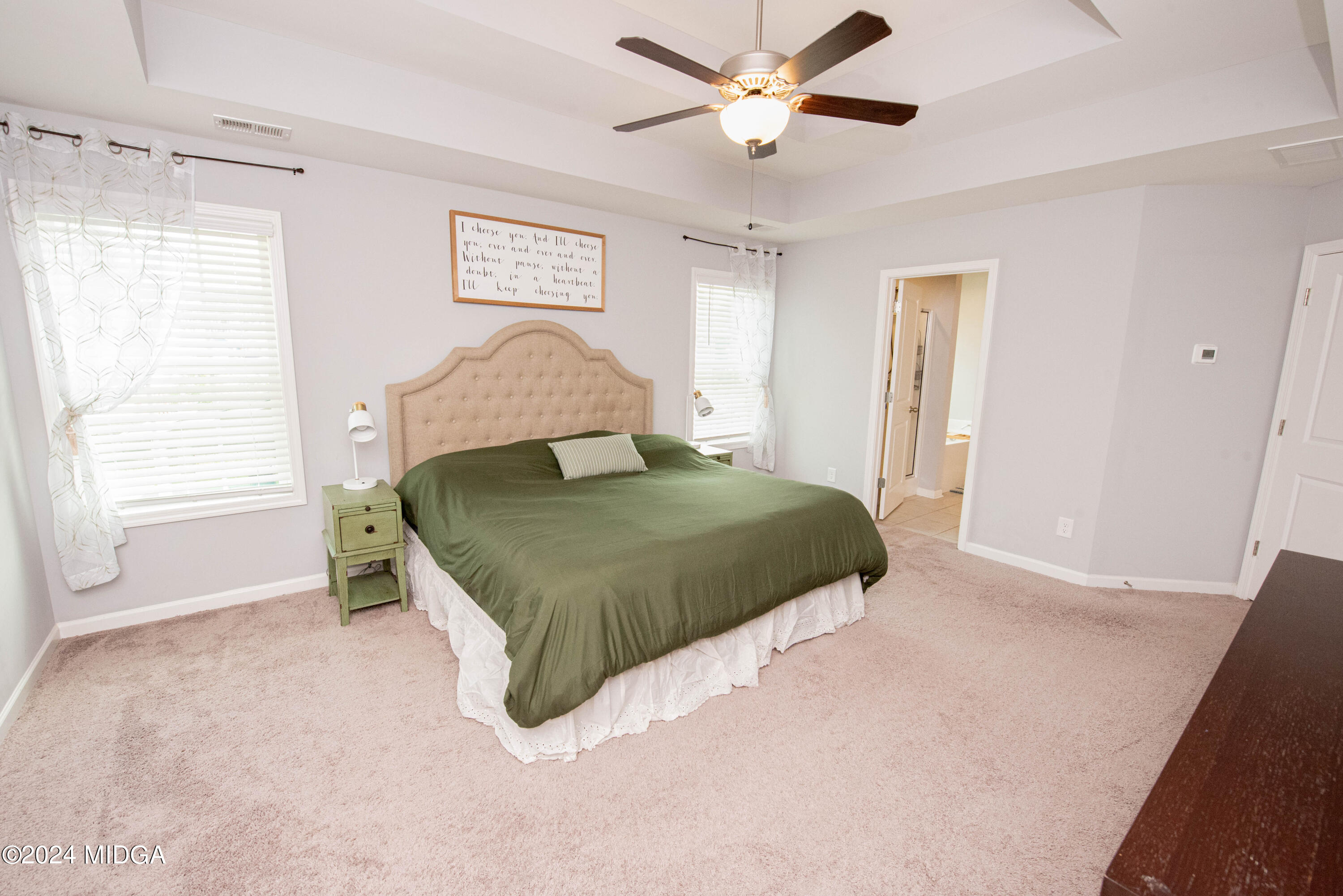 103 Wax Myrtle Way Perry, GA 31069 - Photo 38 of 62 a bedroom with a large bed and a chandelier