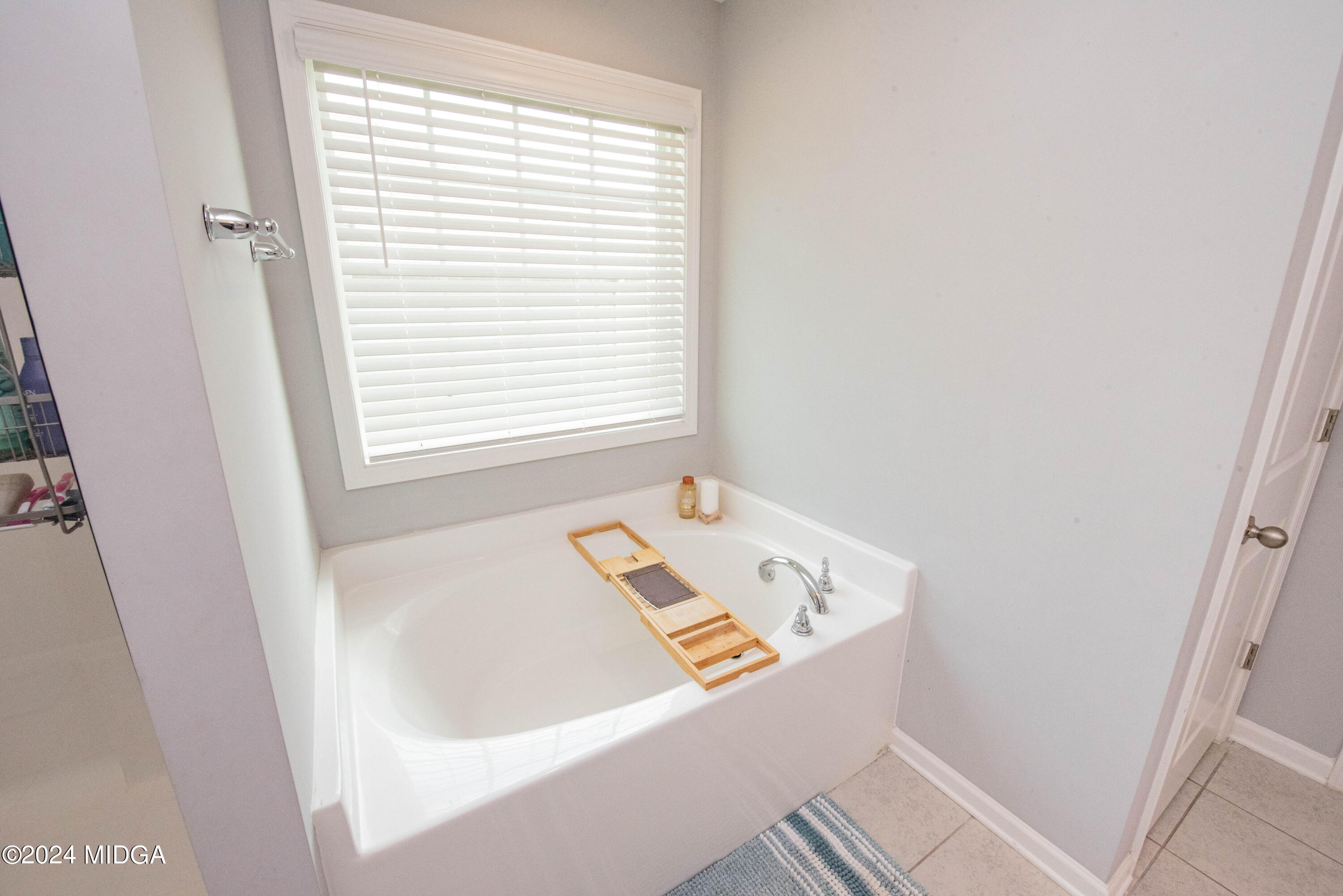 103 Wax Myrtle Way Perry, GA 31069 - Photo 41 of 62 a bath tub sitting in a bathroom next to a window
