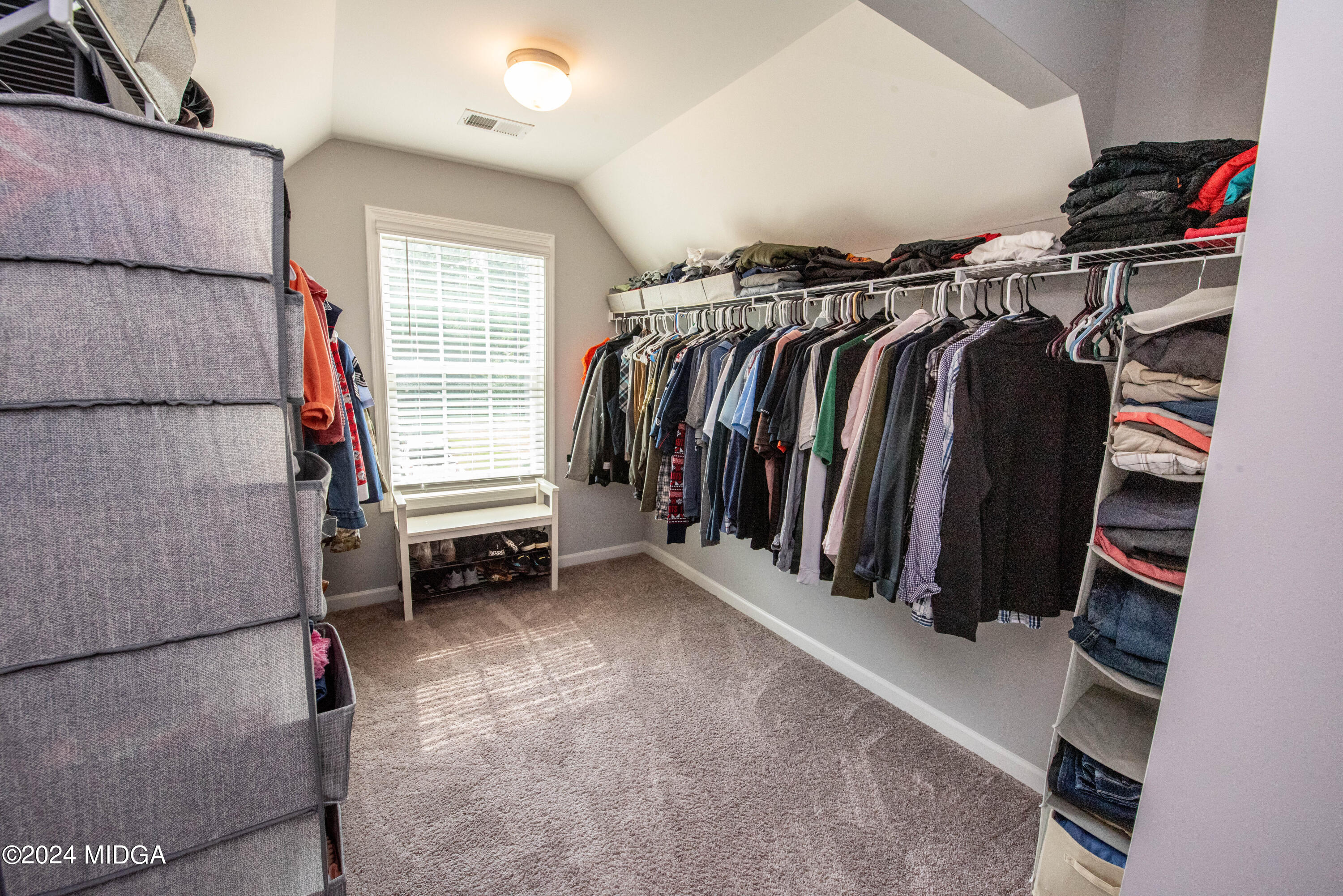 103 Wax Myrtle Way Perry, GA 31069 - Photo 45 of 62 a view of walk in closet with clothes and shoes