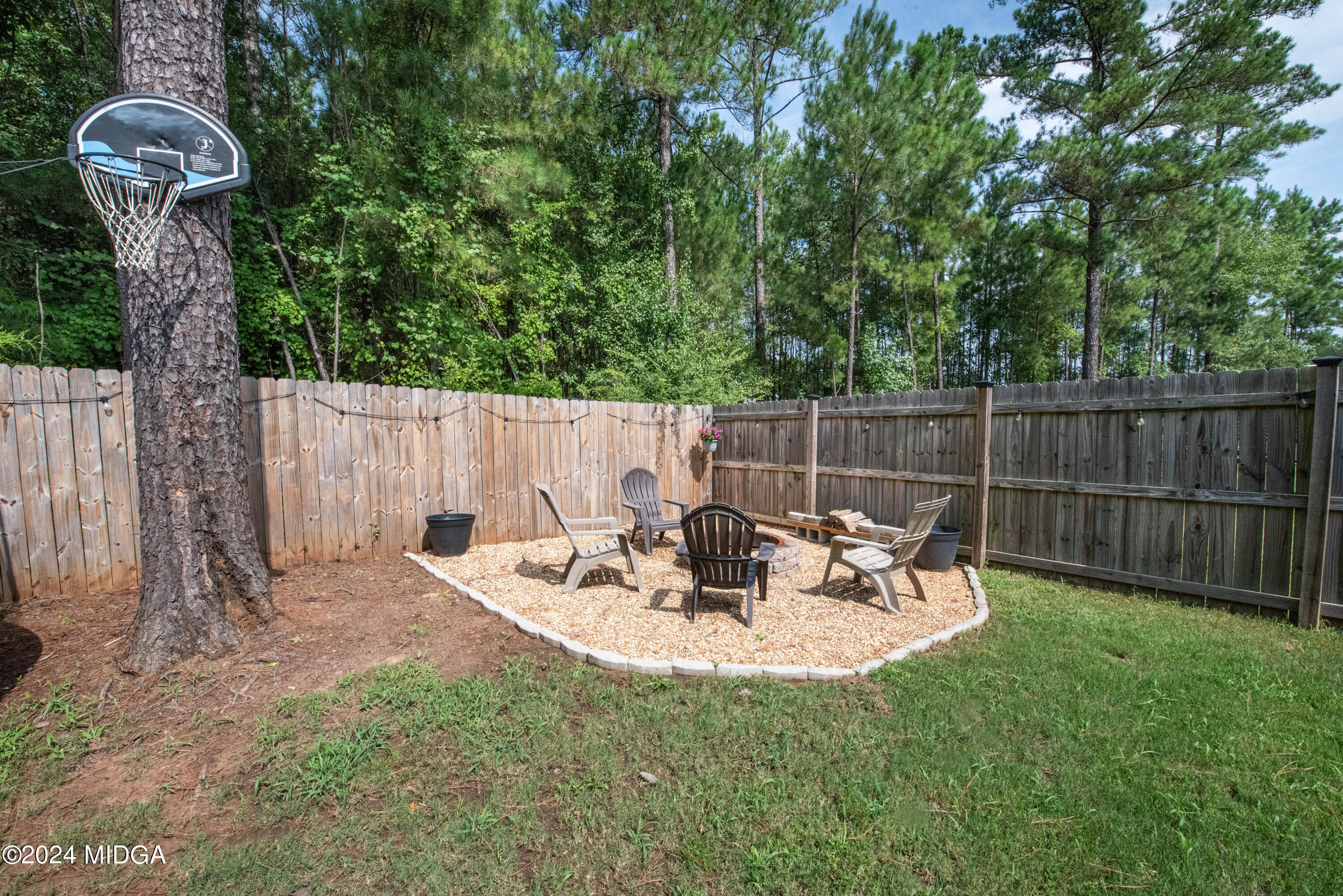 103 Wax Myrtle Way Perry, GA 31069 - Photo 58 of 62 a view of backyard with table and chairs and wooden fence