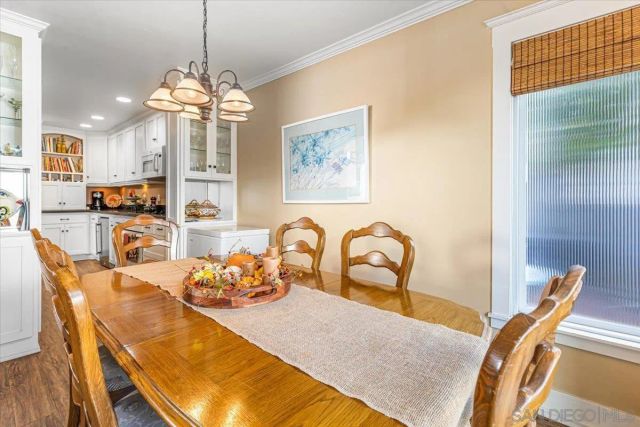 a dining room with furniture and chandelier