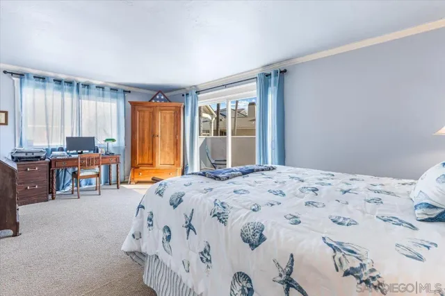 a bedroom with a bed and large windows