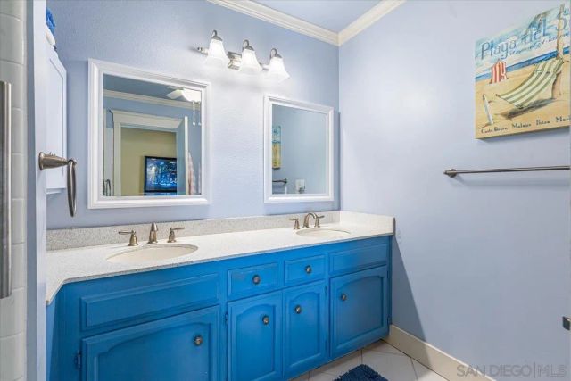 a bathroom with a double vanity sink and a mirror
