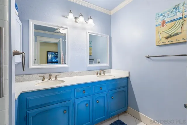 a bathroom with a double vanity sink and a mirror