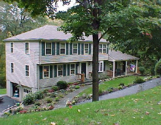 175 Deer Run Road Wilton, CT 06897 - Photo 1 of 1 a front view of a house with a garden