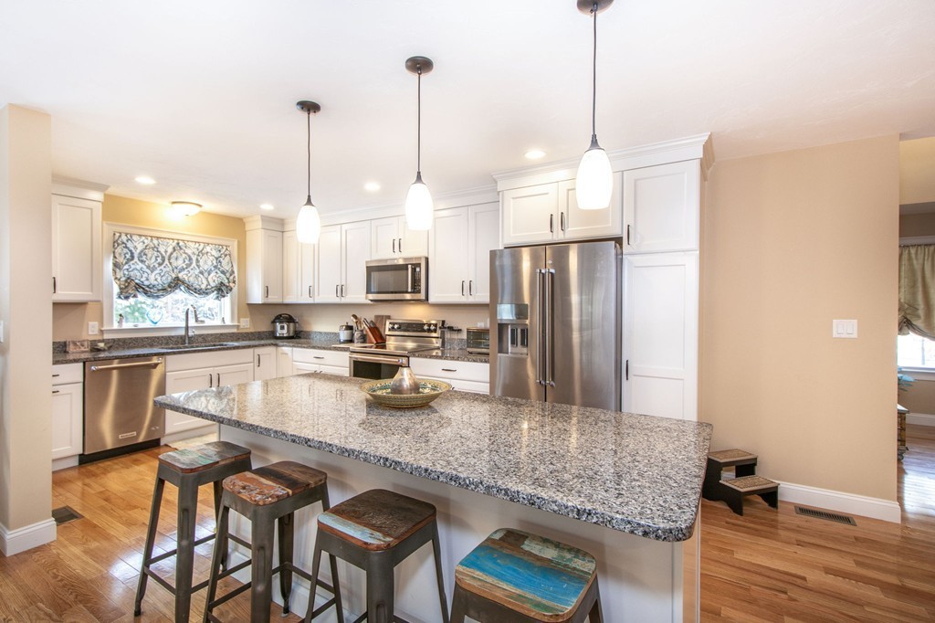 4 Kevin's Way, Unit 4 Scituate, MA 02066 - Photo 12 of 26 a kitchen with stainless steel appliances granite countertop a refrigerator a stove and a sink
