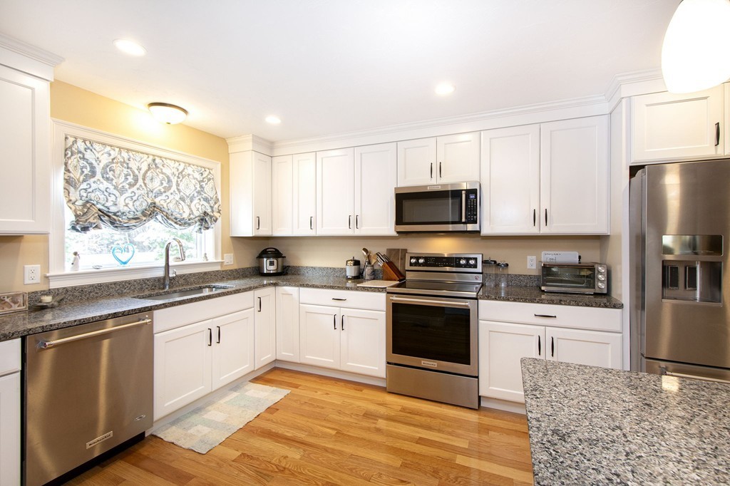 4 Kevin's Way, Unit 4 Scituate, MA 02066 - Photo 13 of 26 a kitchen with granite countertop a sink stainless steel appliances and cabinets