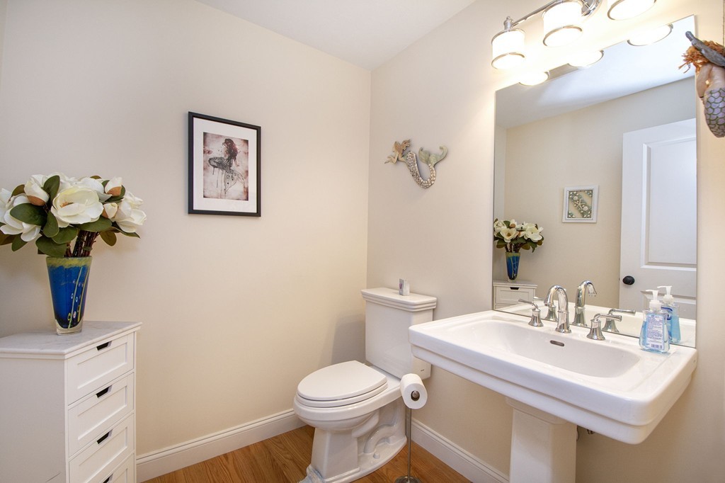 4 Kevin's Way, Unit 4 Scituate, MA 02066 - Photo 15 of 26 a bathroom with a sink mirror and toilet