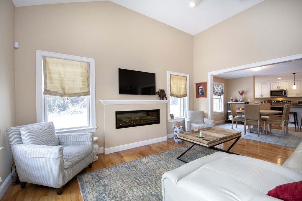 4 Kevin's Way, Unit 4 Scituate, MA 02066 - Photo 17 of 26 a living room with furniture a fireplace and a flat screen tv