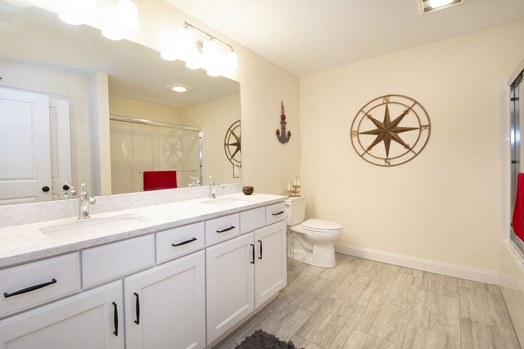 4 Kevin's Way, Unit 4 Scituate, MA 02066 - Photo 23 of 26 a bathroom with a double vanity sink and a mirror