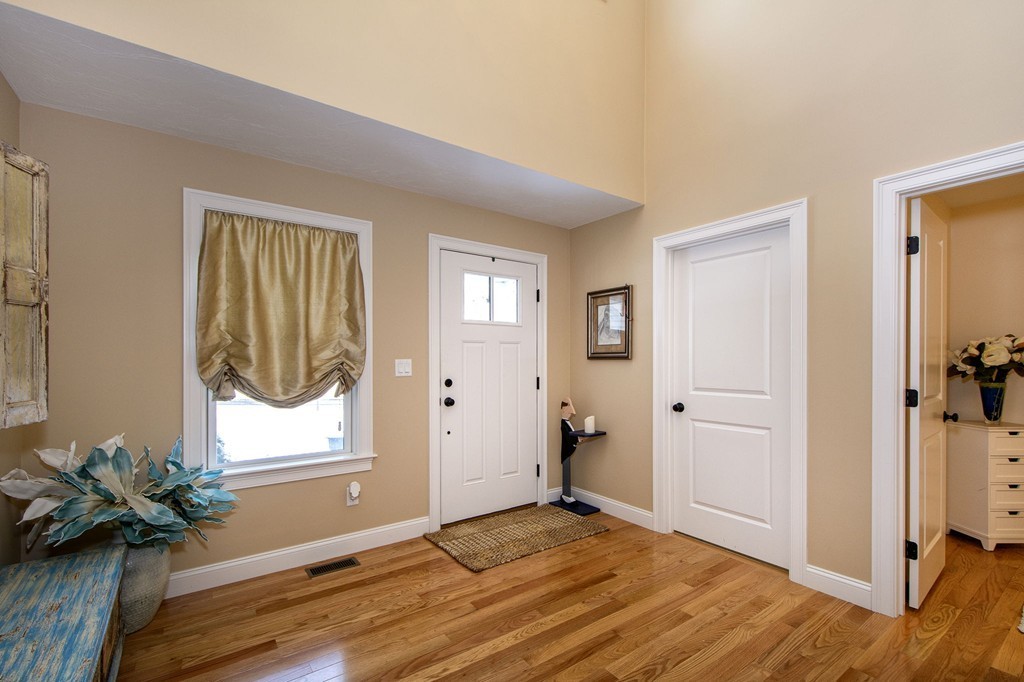 4 Kevin's Way, Unit 4 Scituate, MA 02066 - Photo 6 of 26 a view of an entryway with wooden floor and a livingroom