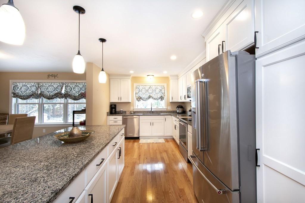 4 Kevin's Way, Unit 4 Scituate, MA 02066 - Photo 9 of 26 a kitchen with stainless steel appliances granite countertop a refrigerator a sink and a stove