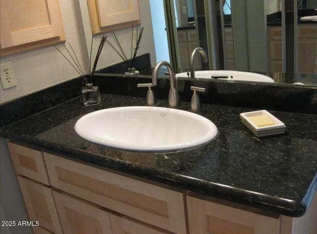 a bathroom with a tub a mirror and a shower