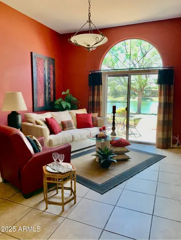 a living room with furniture and a large window