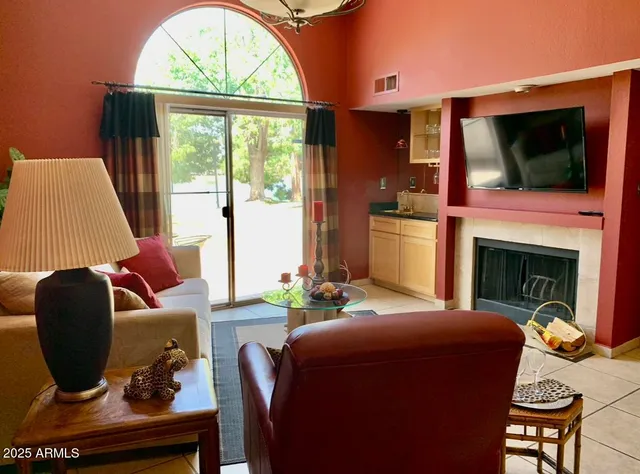 a living room with furniture fireplace and flat screen tv