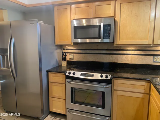 a kitchen with a stove microwave and refrigerator