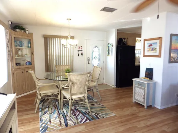 a kitchen with a refrigerator stove and white cabinets