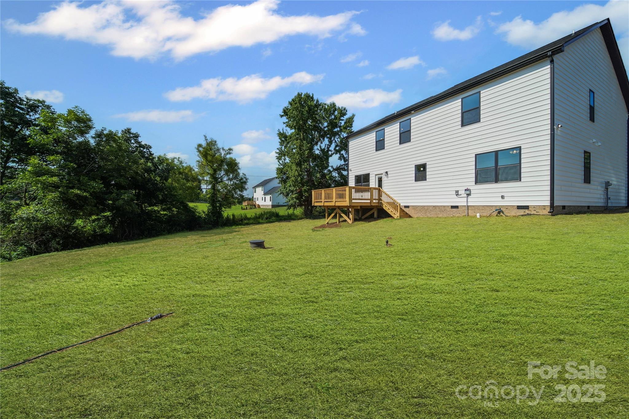 1308 Austin Chaney Road Wingate, NC 28174 - Photo 15 of 48 a view of a white house with a big yard