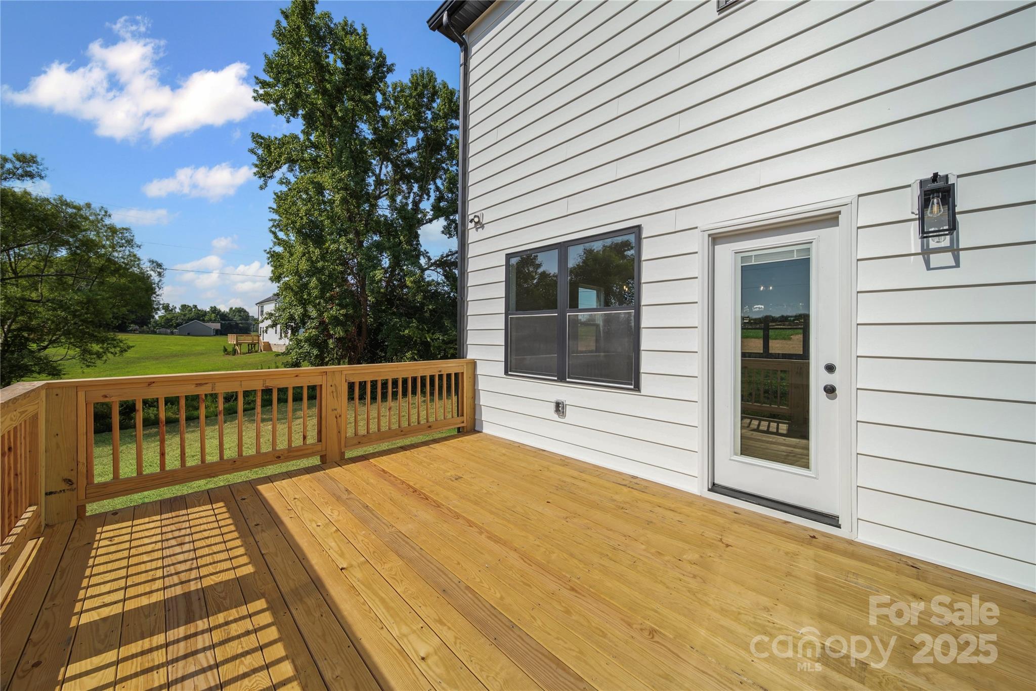 1308 Austin Chaney Road Wingate, NC 28174 - Photo 17 of 48 a view of balcony with wooden floor and fence and a potted plant