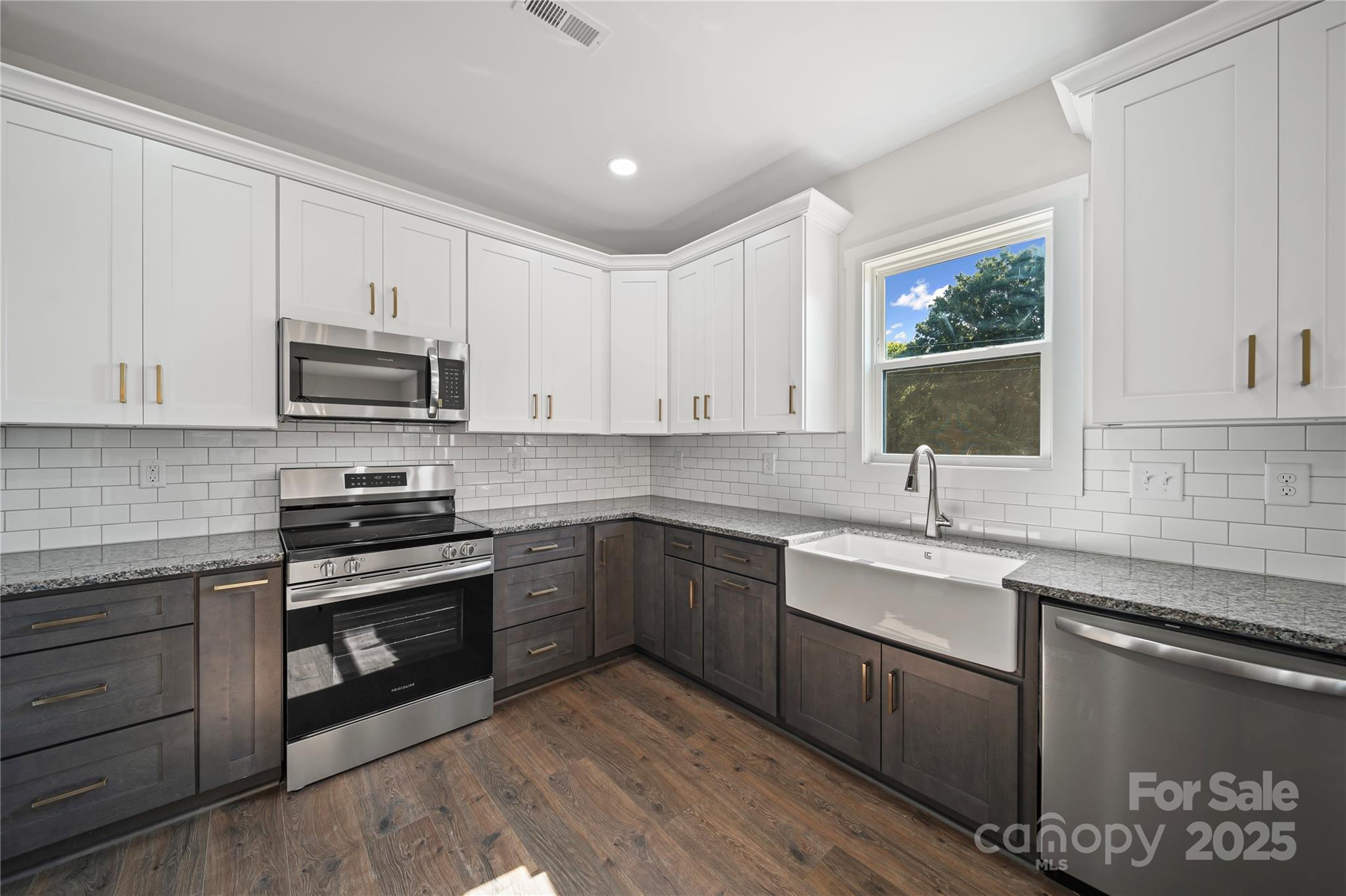 1308 Austin Chaney Road Wingate, NC 28174 - Photo 23 of 48 a kitchen with stainless steel appliances granite countertop a sink stove and microwave