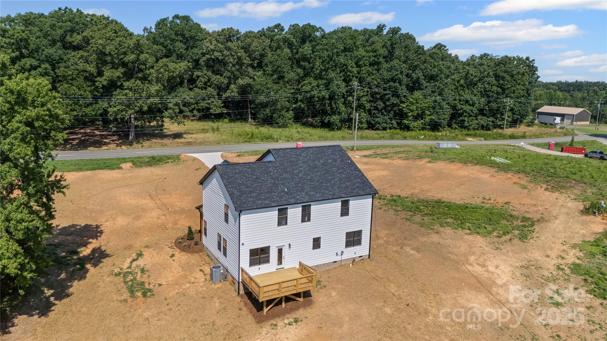 1308 Austin Chaney Road Wingate, NC 28174 - Photo 29 of 48 an aerial view of a house with garden space and trees all around