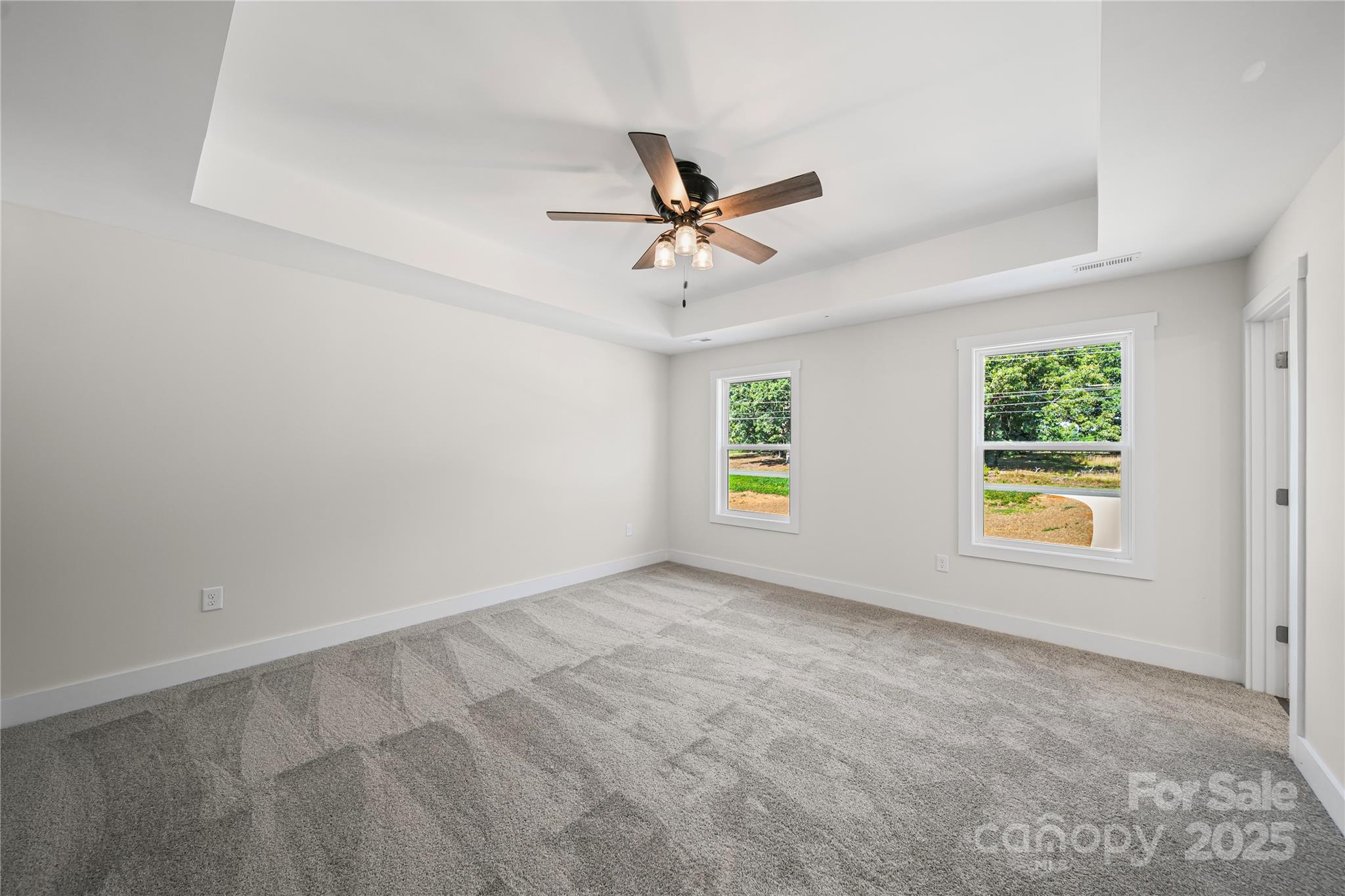1308 Austin Chaney Road Wingate, NC 28174 - Photo 35 of 48 an empty room with windows and fan