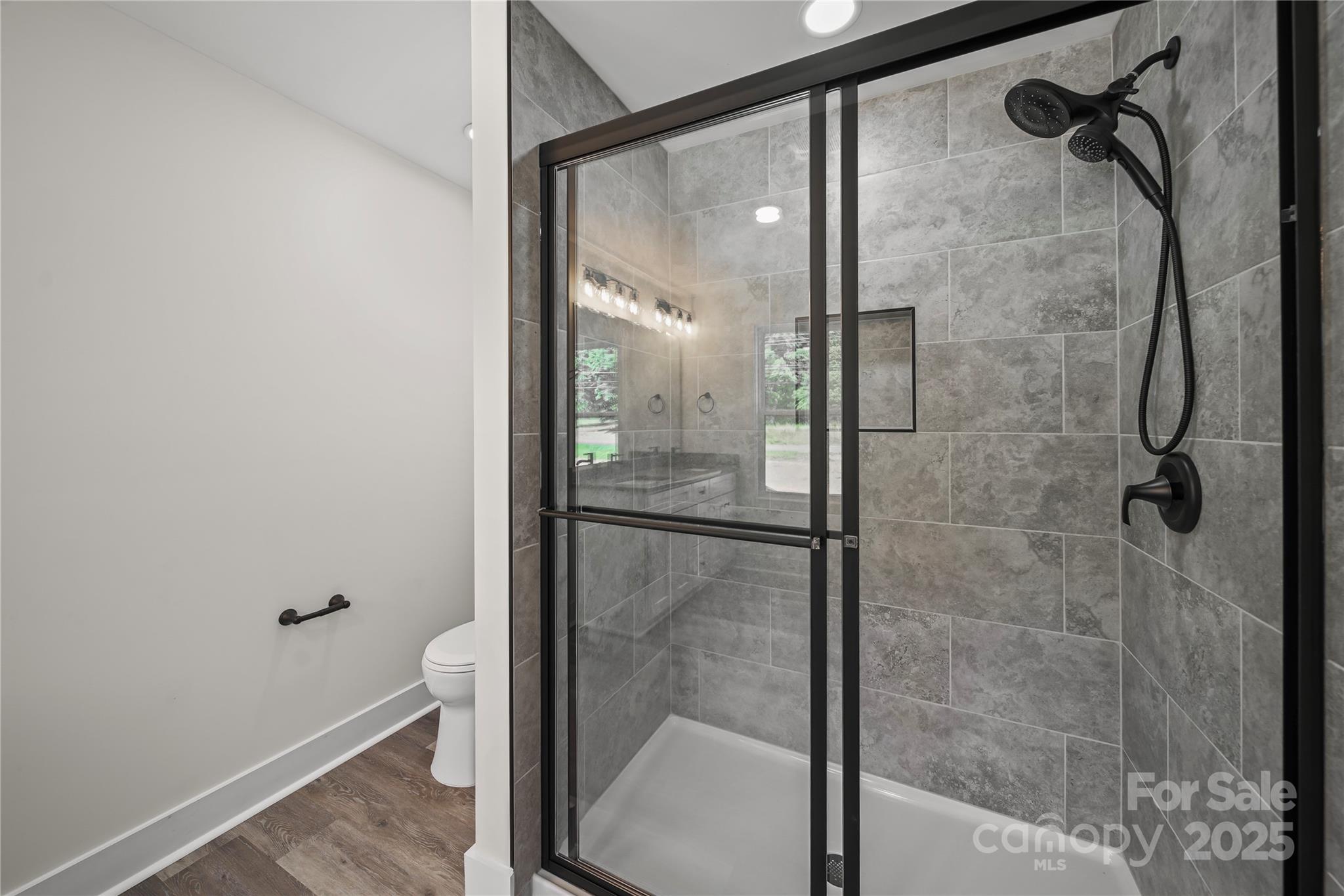 1308 Austin Chaney Road Wingate, NC 28174 - Photo 38 of 48 a bathroom with a glass shower door