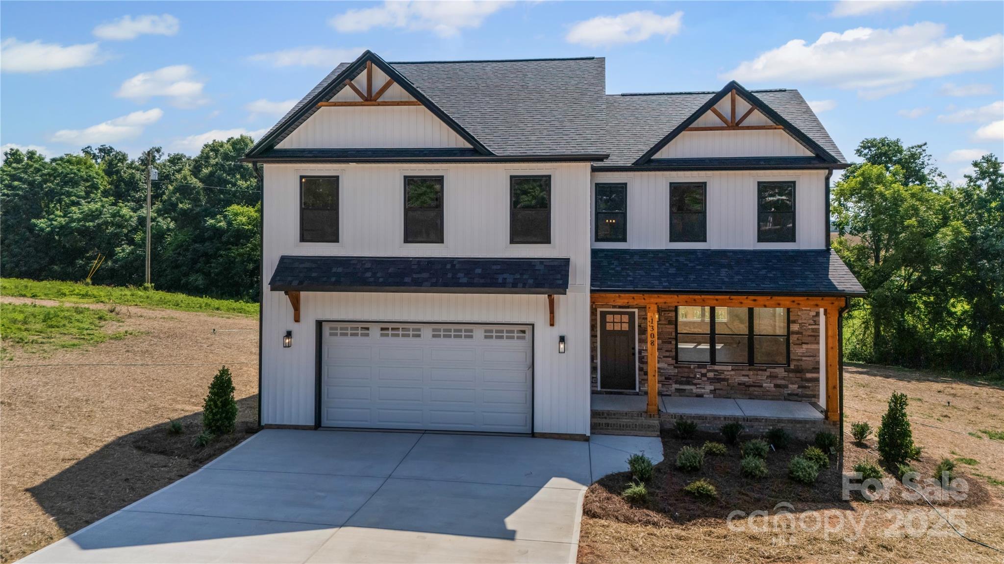 1308 Austin Chaney Road Wingate, NC 28174 - Photo 4 of 48 a front view of a house with a garden and garage