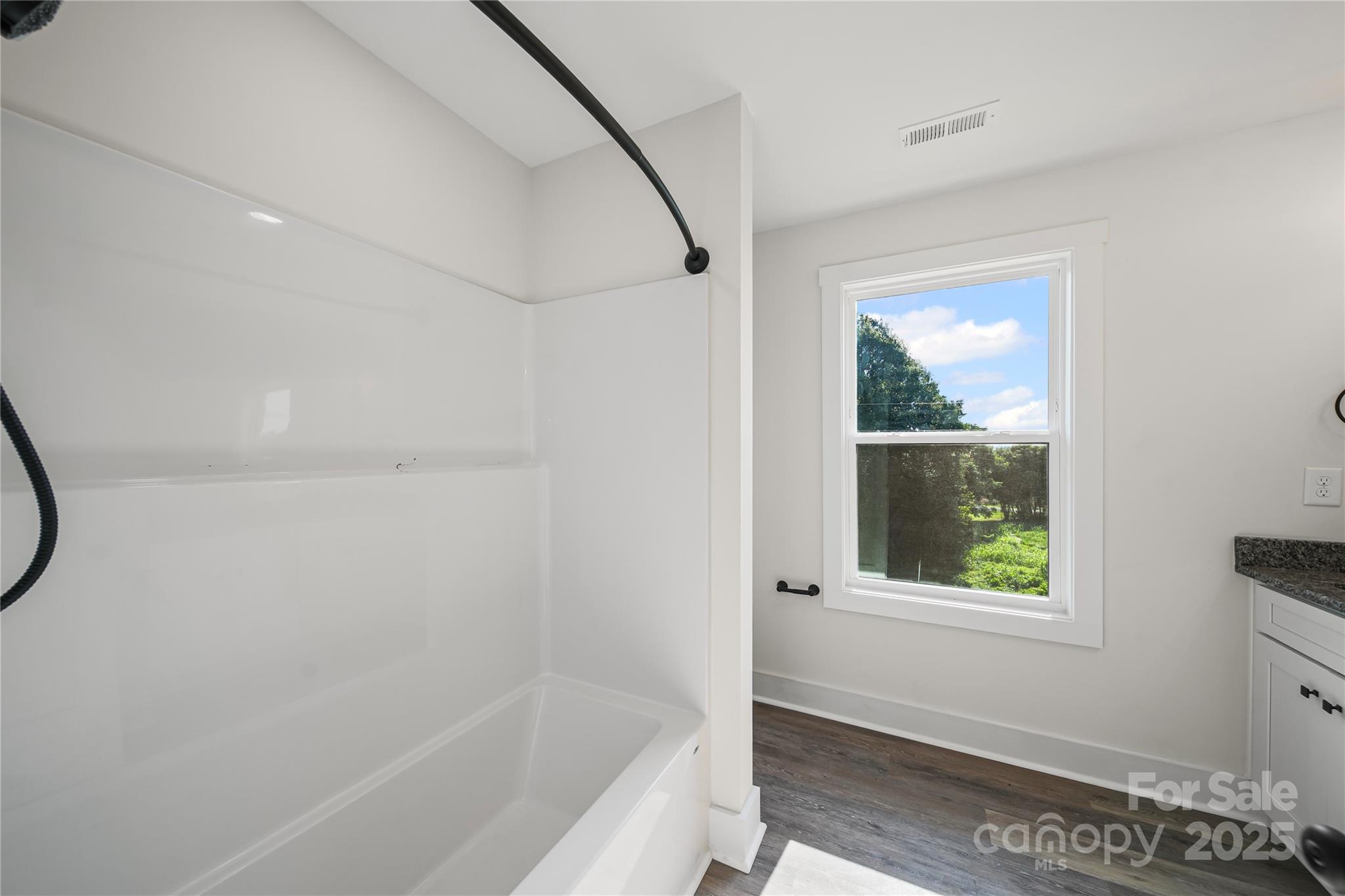 1308 Austin Chaney Road Wingate, NC 28174 - Photo 44 of 48 a bathroom with a bathtub and a window