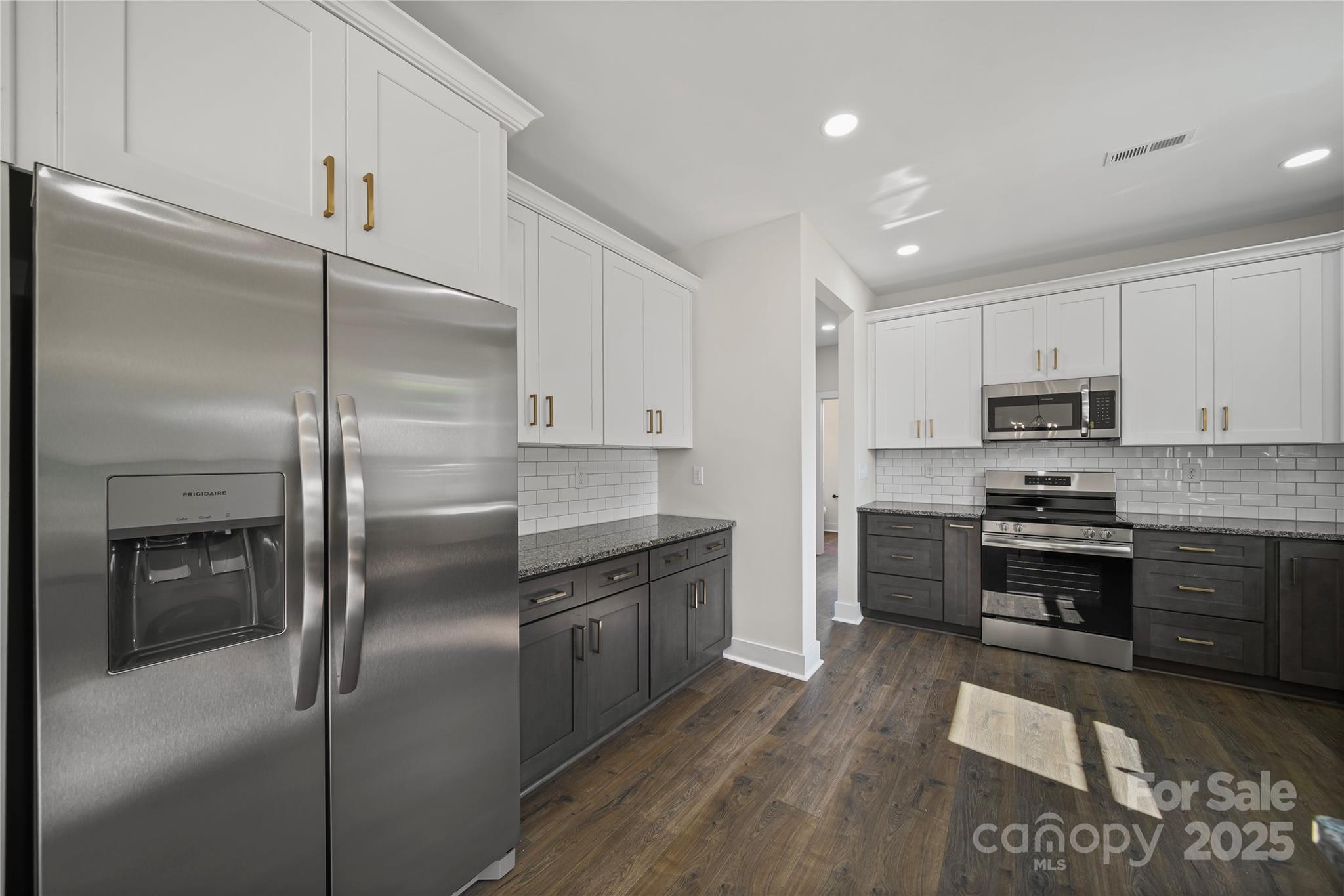 1308 Austin Chaney Road Wingate, NC 28174 - Photo 7 of 48 a kitchen with stainless steel appliances granite countertop a stove a refrigerator and a refrigerator