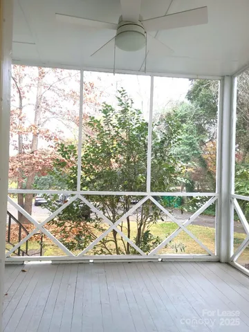 a view of a room with wooden floor and windows