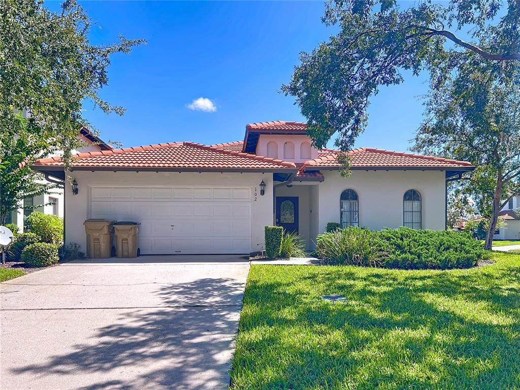 a front view of a house with a yard and garage