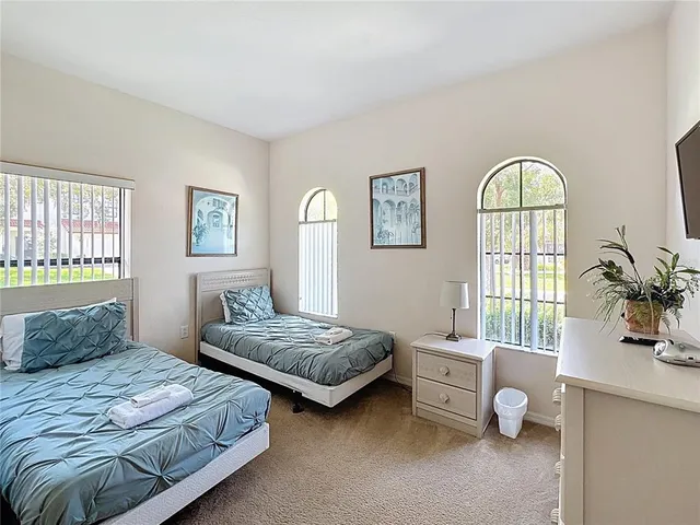 a bedroom with two beds and a window