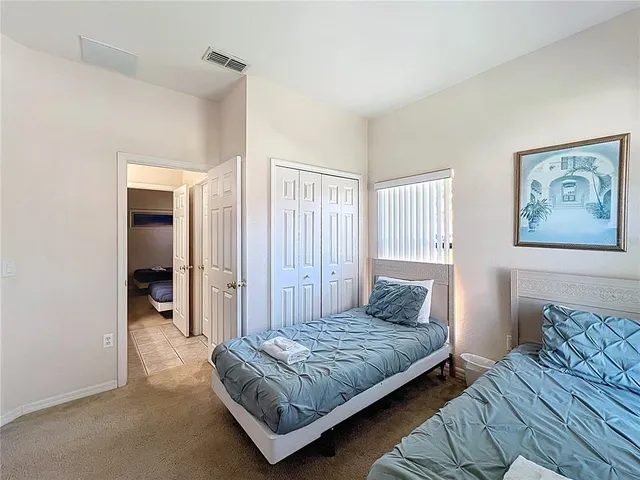 a bedroom with a bed and a couch