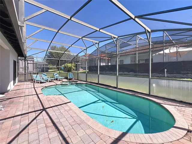 a view of a backyard with a swimming pool