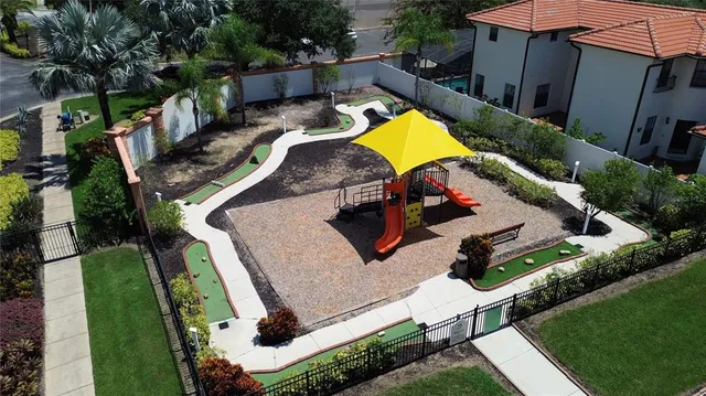 an aerial view of a house with swimming pool and porch