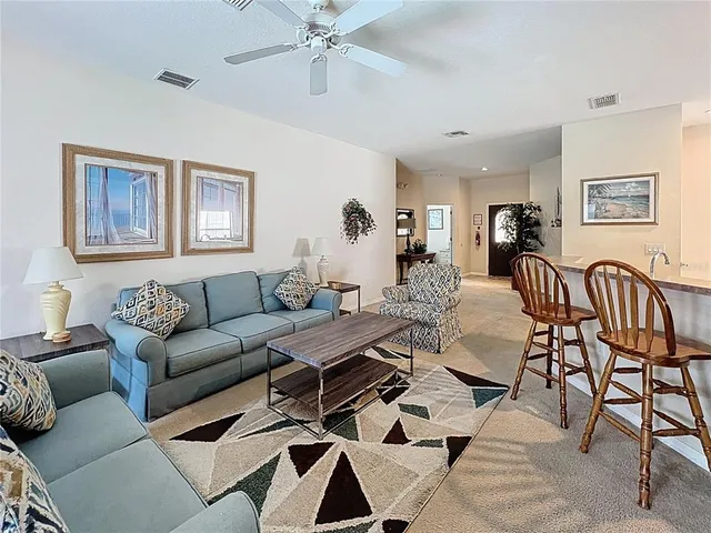 a living room with furniture and a view of dining room