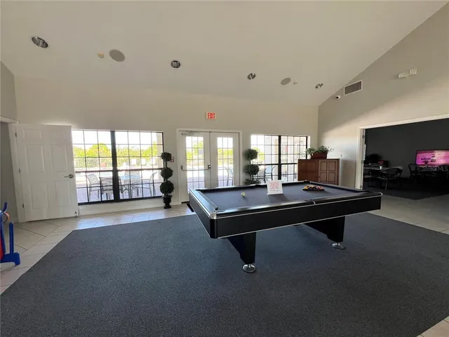 a living room with furniture pool table and a fireplace